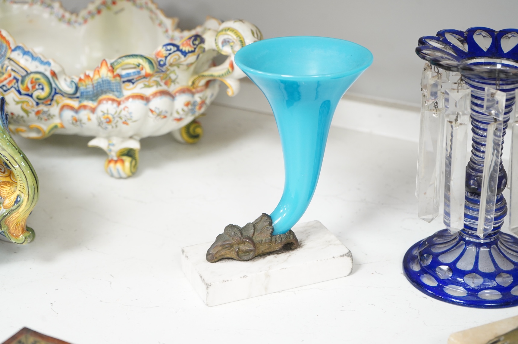 A late 19th century blue overlay glass table lustre and two late 19th century cornucopia shaped glass and brass mounted vases on stands